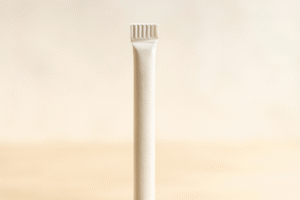 Close-up of beige paper straw upright.